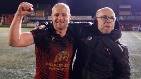 Tom Tonks and manager Andy Peaks celebrate Tamworth's FA Cup victory over Huddersfield Town