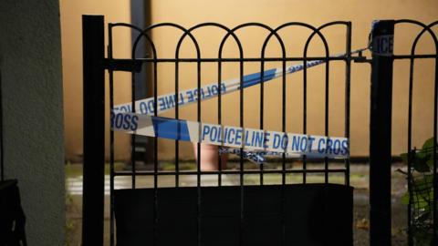 Police tape sealing off a gate at the scene of the attack in Stratford