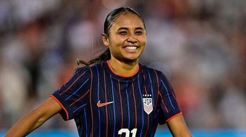 Alyssa Thompson smiling in USA kit