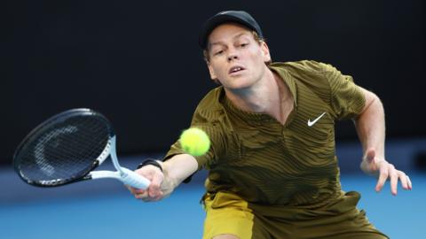 Jannik Sinner hits a forehand