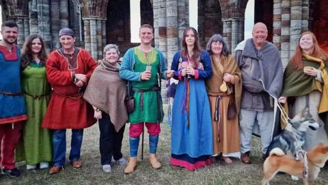 A group of people dressed in colourful Viking outfits