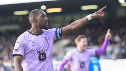 Tendayi Darikwa of Lincoln City celebrates scoring his side's second goal at Peterborough