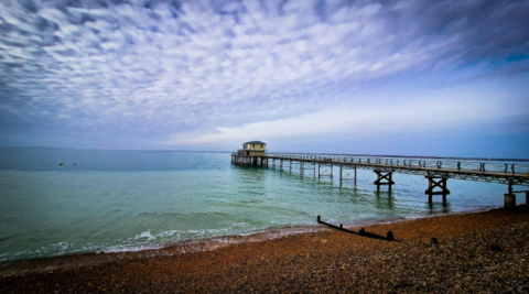 Totland Bay, Isle of Wight with beautiful clouds and sea view past the pier.