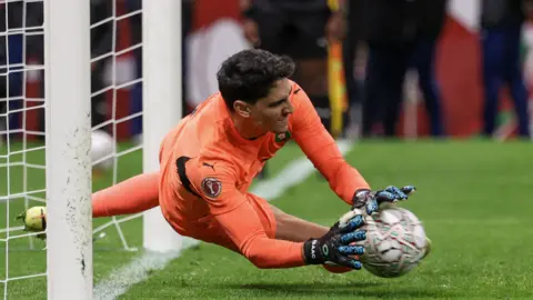 Yassine Bounou saves a penalty against Nigeria