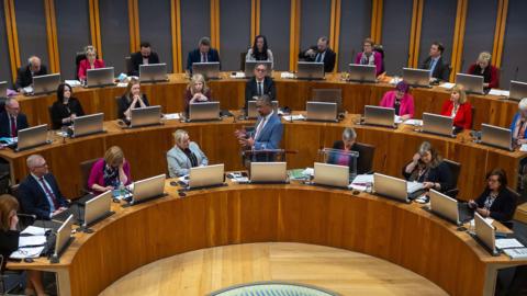 Politicians in the Senedd chamber