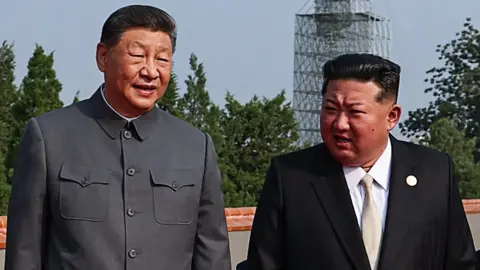 Chinese President Xi Jinping and North Korean leader Kim Jong Un walking side by side