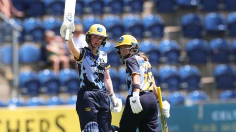 Glamorgan's Bethan Ellis (left) celebrates her half century