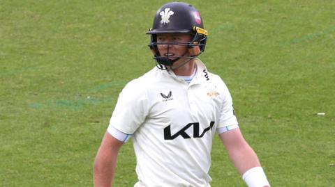 Ollie Pope walks off the field