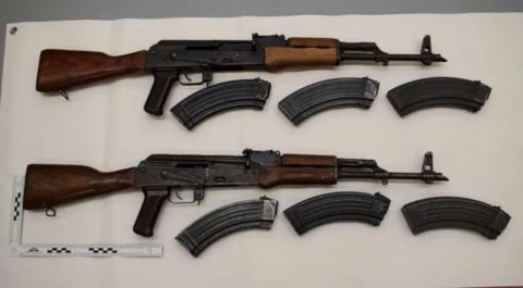 Two rifles surround magazines on a white background.