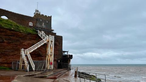 The Jacob's Ladder white steps from the beach to the Clock Tower and Connaught Gardens with fencing around the base of the steps and the sea to the right.