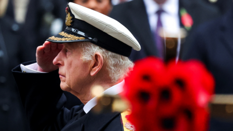 King Charles III saluting at Remembrance Sunday event.