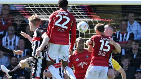 Adebola Oluwo heads home for Salford City at Grimsby Town