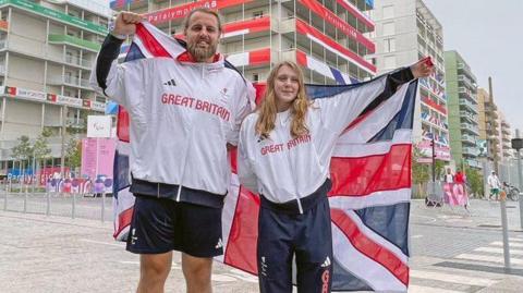 Matt Bush and Poppy Maskill holding the Union flag behind them