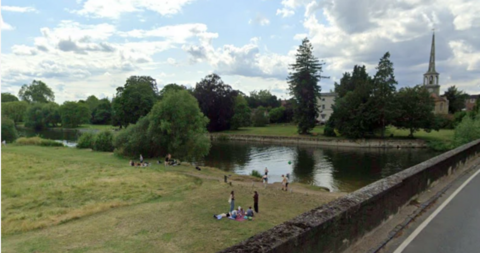 Google image of Wallingford beach with a church and greenery in the background.