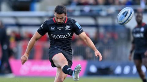 Alex Lozowski kicks the ball forward for Saracens during the win over Sale Sharks