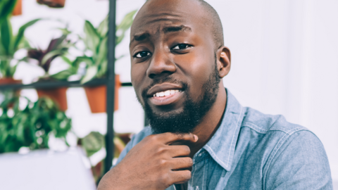 A man looks at the camera half-smiling 