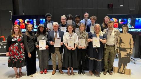 Andy Serkis with winners of art competition 