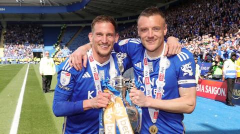 Marc Albrighton (left) and Jamie Vardy hold the Championship trophy at the King Power Stadium