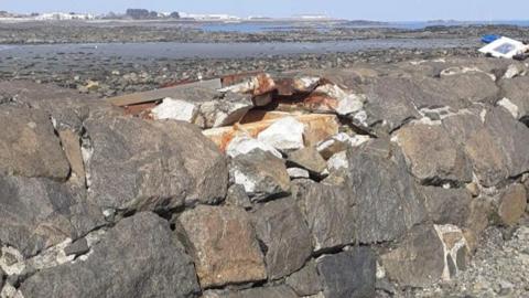 A damage sewer pipe. Granite rocks used to protect the pipe and steel covers have been ripped off the structure by stormy weather.