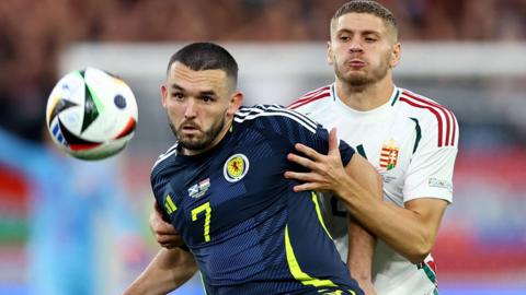 Scotland's John McGinn in action against Hungary's Marton Dardai during the 2024 European Champinships in Germany  