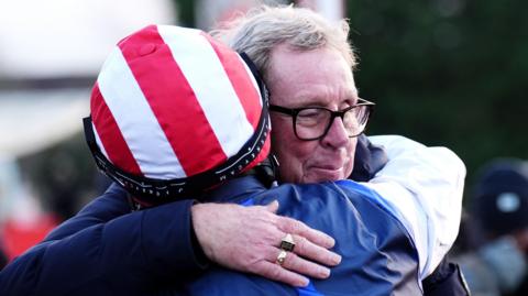 Jockey Ben Jones hugs owner Harry Redknapp after The Jukebox Man wins the 2025 King George VI Chase at Kempton Park