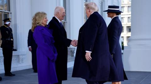 The Bidens and Trumps shaking hands outside the White House