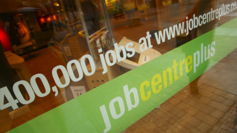 Job centre window showing the number of vacancies. Job Centre Plus branding runs across the window - a green banner with white and yellow lettering.