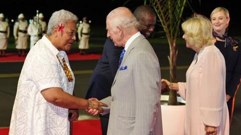 Britain's King Charles and Queen Camilla are greeted by Samoa's Prime Minister Fiame Naomi Mata'afa as they arrive at Faleolo International Airport in Samoa