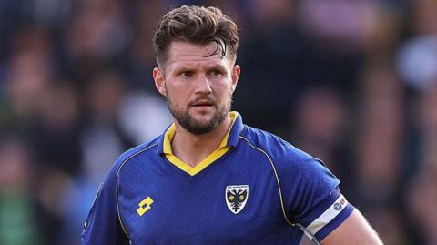 Jake Reeves in action for AFC Wimbledon