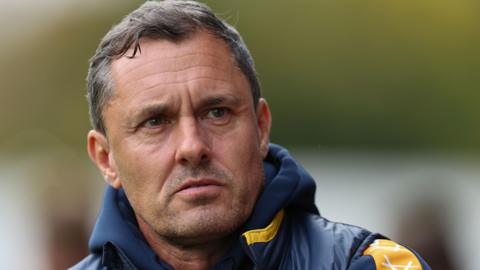 Paul Hurst looks across at his player when in charge of Shrewsbury Town