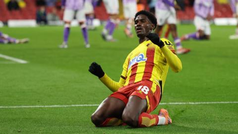 Watford striker Vivaldo Semedo slides on his knees in celebration after equalising for his side in the final minute of their championship game against Sheffield Wednesday