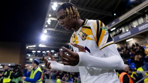 Kyle Hudlin walks on to the pitch at Wimbledon earlier this month