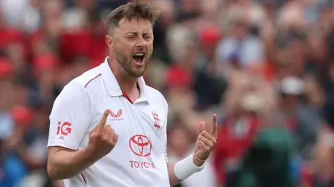 England bowler Ollie Robinson celebrates taking a wicket