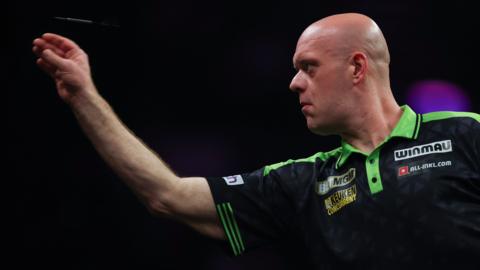 Michael van Gerwen throws a dart