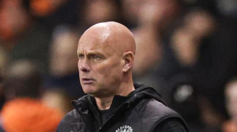 Blackpool assistant Steve Agnew standing on the touchline while deputising for manager Steve Bruce. 