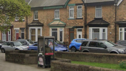 A BT phone box on a street in Scarborough