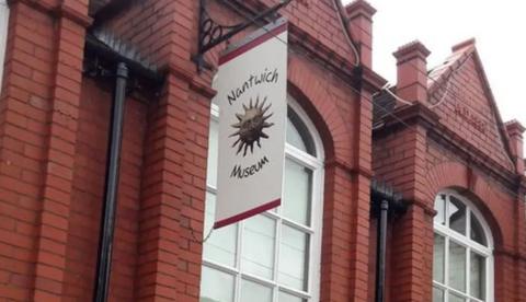 A large brick building with a white banner hanging from the side, with the words Nantwich Museum.