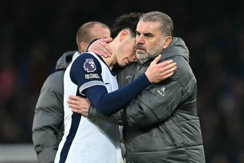 Tottenham manager Ange Postecoglou hugs a player