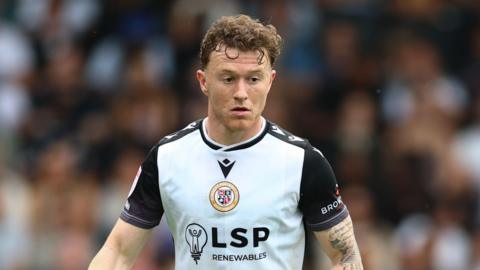Jude Arthurs playing for Bromley in their white shirt with black sleeves