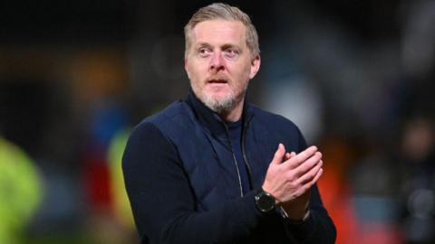 Garry Monk applauds the Cambridge United crowd after a game.