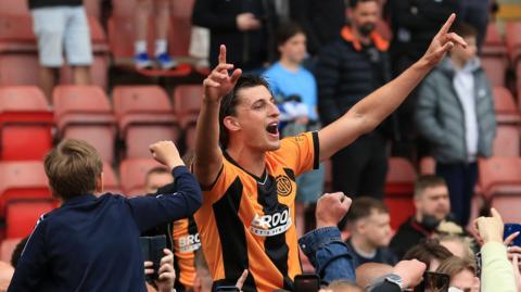 Cambridge celebrate promotion after drawing with Crewe