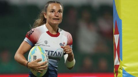 Jasmine Joyce-Butchers celebrates scoring a try for Great Britain