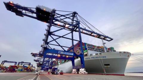 A container ship docked on the quay at Felixstowe port 