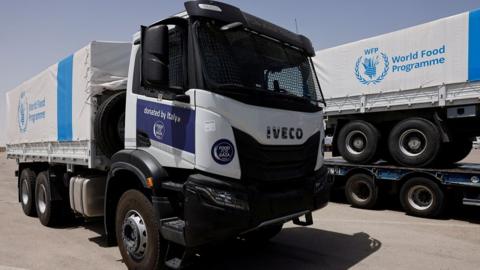 World Food Programme (WFP) trucks waiting at the Kerem Shalom border crossing between Israel and the Gaza Strip on 26 May