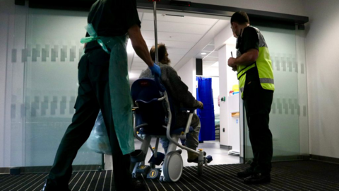 Patient being wheeled into Grange Hospital, Cwmbran