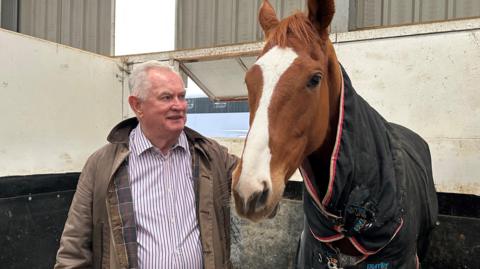 Dai Walters in the stable with one of his racehorses