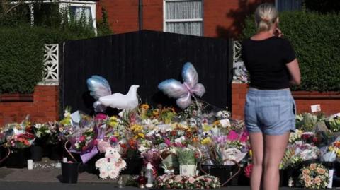 Flowers, balloons and tributes have been left near the scene after the killings