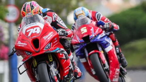 Davey Todd leads Dean Harrison during a Superstock race at the 2024 North West 200