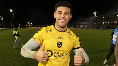 Rio Dyer gives the thumbs-up after a Dragons win at Rodney Parade