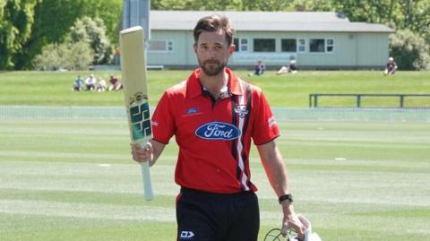 Canterbury's Chad Bowes raises his bat to salute the crowd after his record-breaking innings